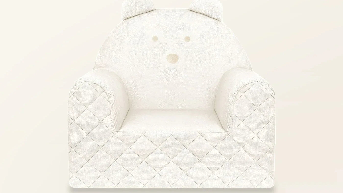 Fauteuil bébé ourson en velours beige capitonné, vue de face, sur fond crème