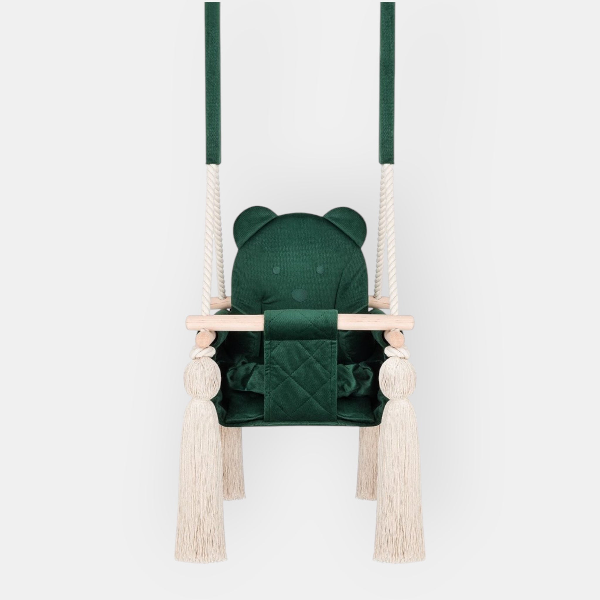 Balançoire bébé en velours vert, vue de face : assise matelassée, barre en bois et pompons