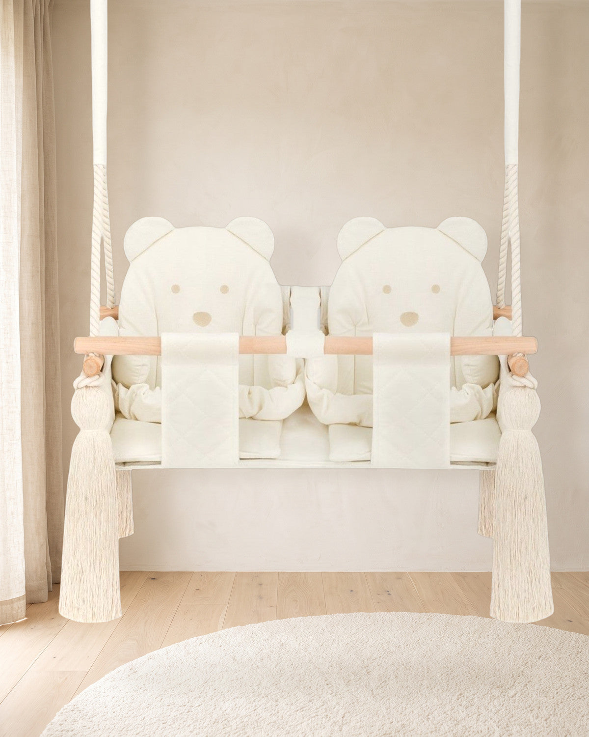 Balançoire double jumeaux en velours beige avec deux dossiers ourson, suspendue dans une chambre d'enfant